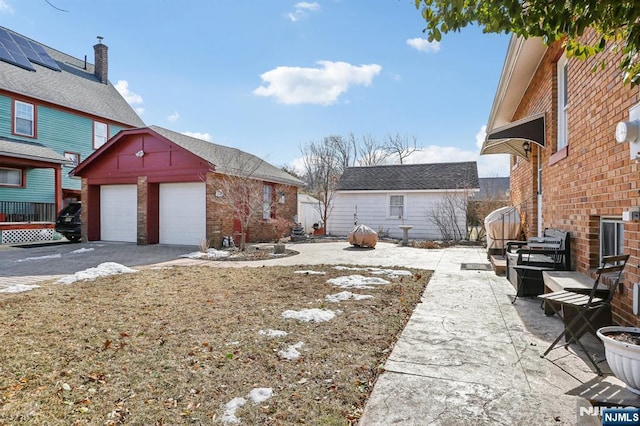 view of yard with an outbuilding and a garage