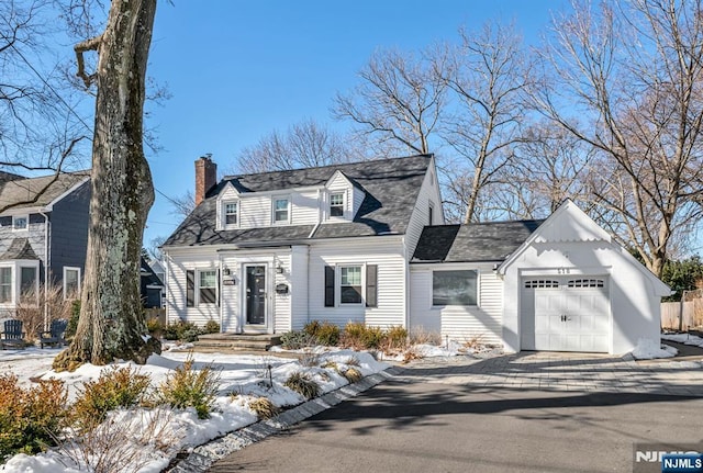 cape cod house featuring a garage