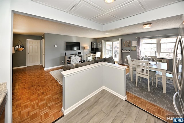 kitchen with stainless steel fridge and parquet flooring