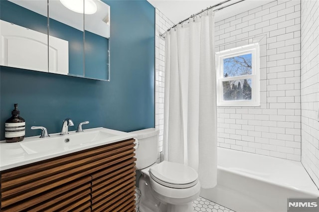 full bathroom with vanity, shower / tub combo with curtain, and toilet