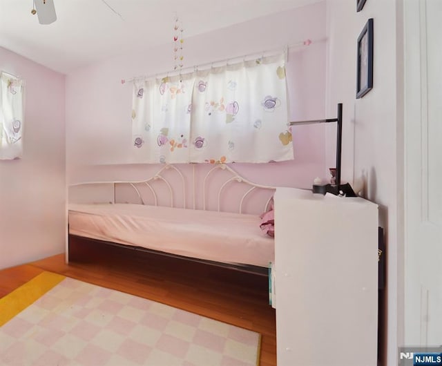 bedroom featuring hardwood / wood-style floors and ceiling fan