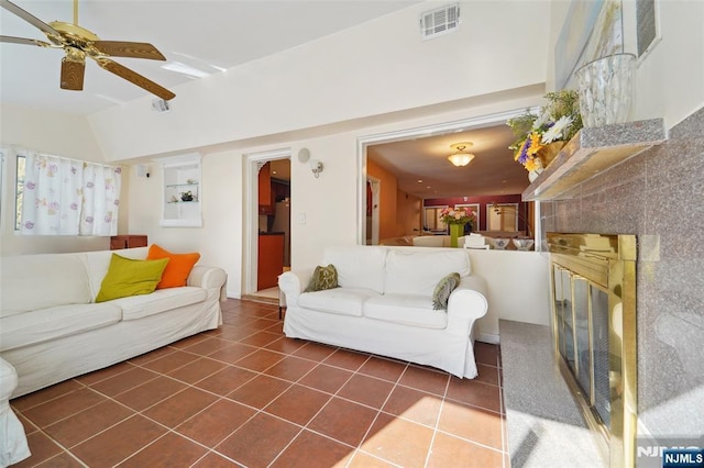 tiled living room featuring lofted ceiling and ceiling fan