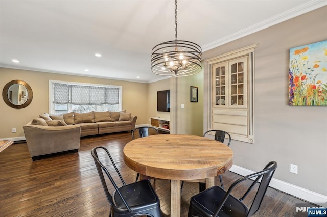 dining space with crown molding, dark wood finished floors, and baseboards