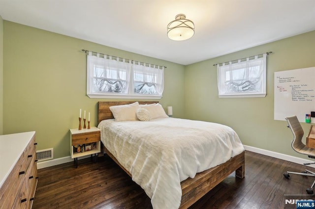 bedroom featuring visible vents, baseboards, and dark wood-style flooring