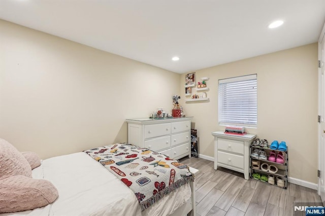 bedroom with recessed lighting, light wood-type flooring, and baseboards