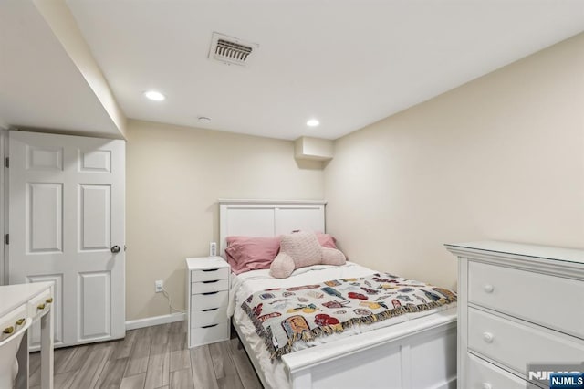 bedroom featuring baseboards, light wood-type flooring, visible vents, and recessed lighting