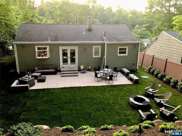 back of property with entry steps, french doors, fence, a yard, and a patio area