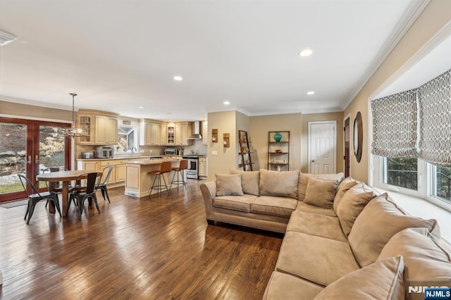 living area with french doors, dark wood-type flooring, recessed lighting, and crown molding