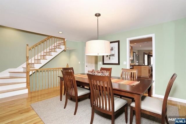 dining space with hardwood / wood-style floors