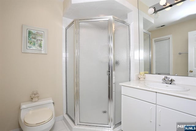 bathroom with vanity, an enclosed shower, and toilet