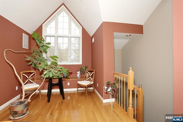 sitting room featuring light hardwood / wood-style floors and lofted ceiling