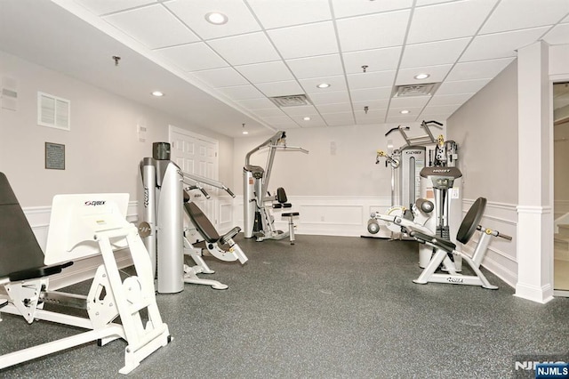 exercise room with a paneled ceiling