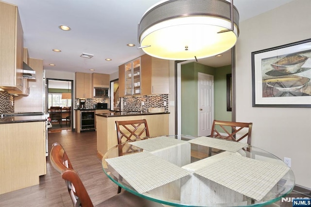 dining space with dark wood-type flooring and wine cooler