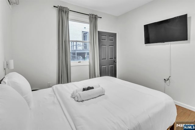 bedroom with wood-type flooring