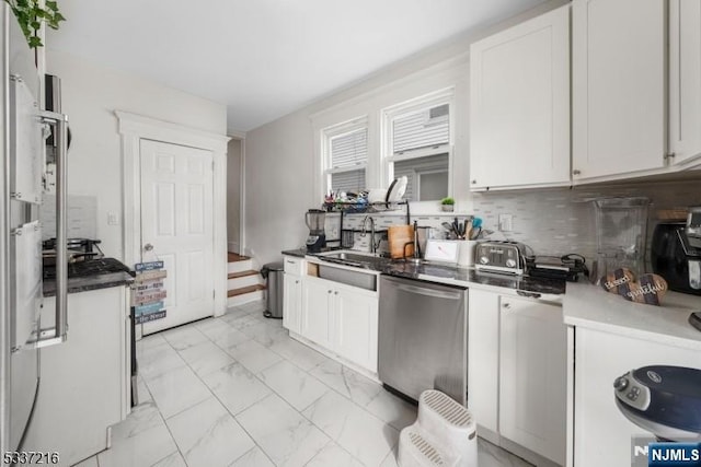 kitchen with white cabinetry, sink, decorative backsplash, and dishwasher