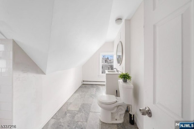 bathroom with vanity, lofted ceiling, a baseboard heating unit, and toilet