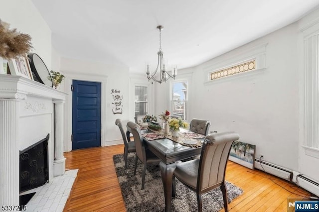 dining room featuring light hardwood / wood-style floors and a chandelier