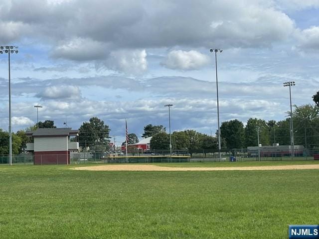 surrounding community featuring a lawn and fence