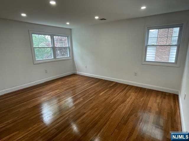 empty room featuring dark hardwood / wood-style flooring