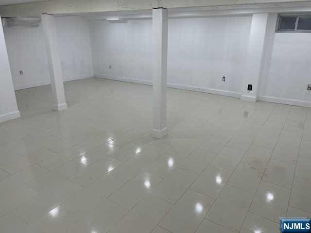 basement featuring light tile patterned floors