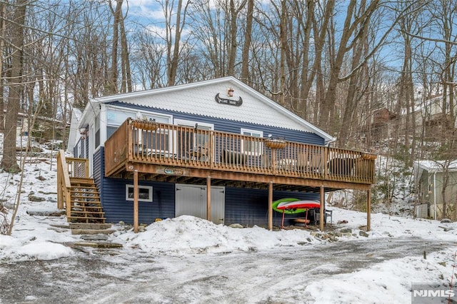 view of front of house featuring stairs and a deck