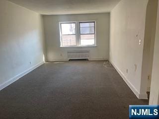 empty room featuring baseboards