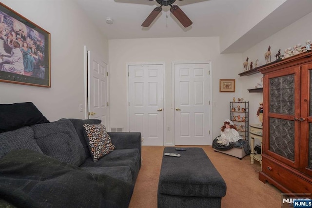 living room with light colored carpet and ceiling fan