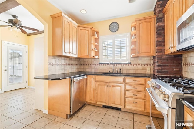 kitchen featuring open shelves, dark countertops, appliances with stainless steel finishes, light brown cabinets, and a sink