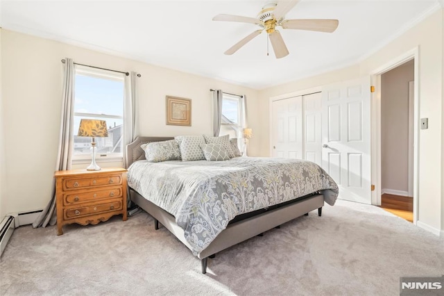 bedroom featuring ceiling fan, baseboards, a closet, and light colored carpet