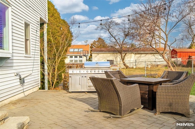 view of patio featuring outdoor dining area, fence, grilling area, and area for grilling