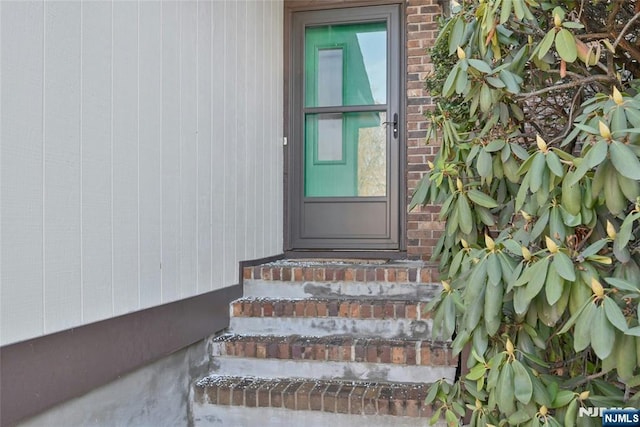 view of exterior entry with brick siding