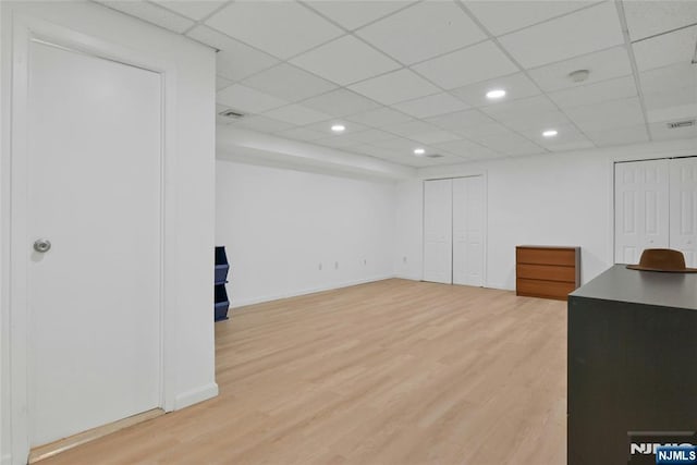 basement featuring recessed lighting, visible vents, a drop ceiling, and wood finished floors