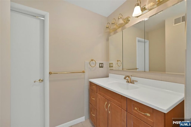 bathroom with tile patterned flooring, visible vents, and vanity