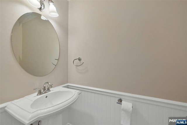 bathroom with a sink and wainscoting