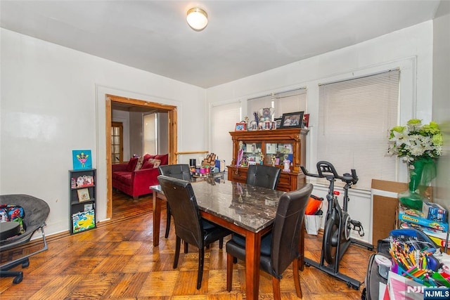 dining room featuring parquet floors