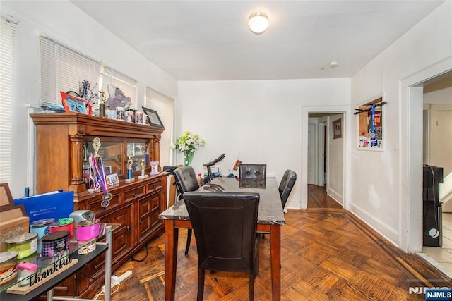 dining room featuring parquet floors