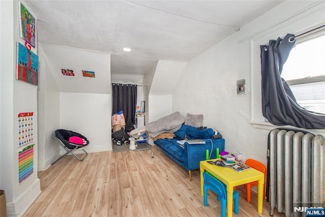 interior space featuring radiator heating unit and light wood-type flooring