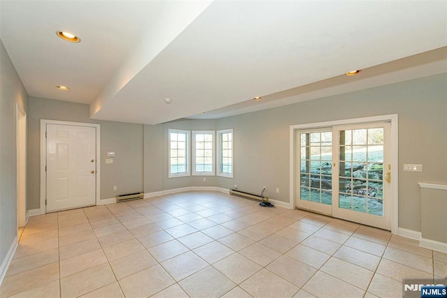 spare room featuring baseboard heating and light tile patterned floors