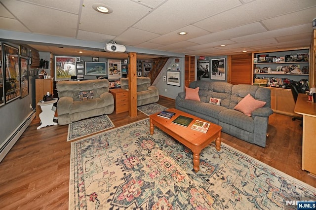 living area with built in features, recessed lighting, wood finished floors, and stairs