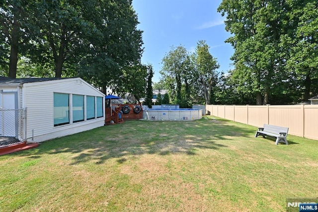 view of yard featuring a fenced backyard and an outdoor pool