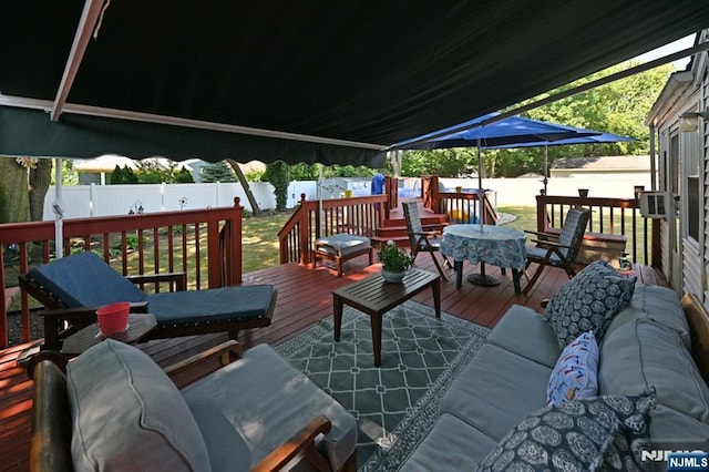 wooden deck featuring a fenced backyard and an outdoor living space