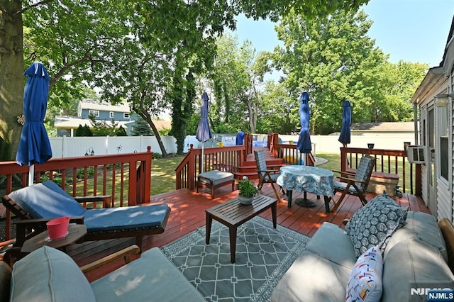 wooden deck with fence and an outdoor living space