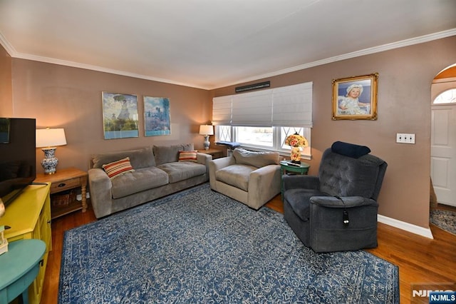 living room with baseboards, ornamental molding, and wood finished floors