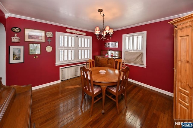 dining area with baseboards, radiator, hardwood / wood-style floors, an inviting chandelier, and crown molding