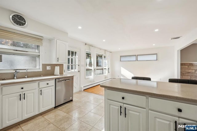 kitchen with a baseboard radiator, dishwasher, backsplash, sink, and white cabinetry