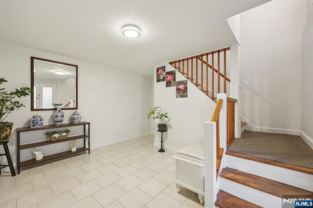 staircase featuring tile patterned floors