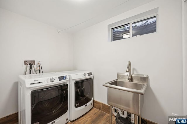 washroom featuring washer and clothes dryer, dark wood-type flooring, and sink