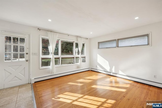 empty room featuring a baseboard heating unit