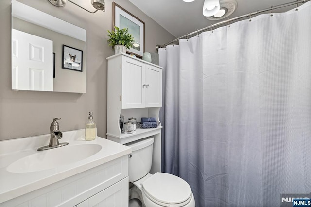 bathroom featuring toilet and vanity