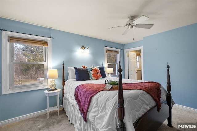 carpeted bedroom featuring ceiling fan, multiple windows, and baseboards